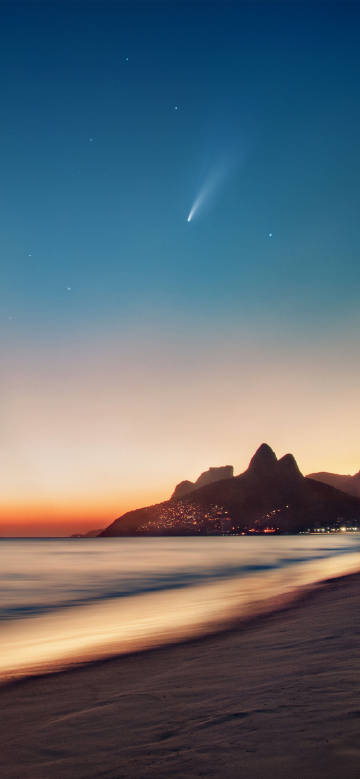 夕阳余晖映照下的海边手机壁纸